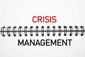 CRISIS MANAGEMENT text on notepad. Financial concept crisis management.